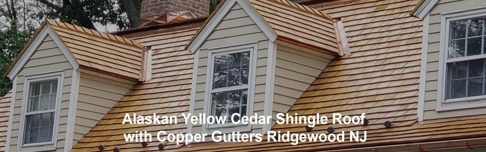 Alaskan yellow cedar shingle roof with copper gutters in Ridgewood, NJ